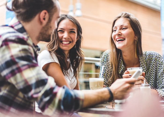 People discussing insurance over cups of coffee