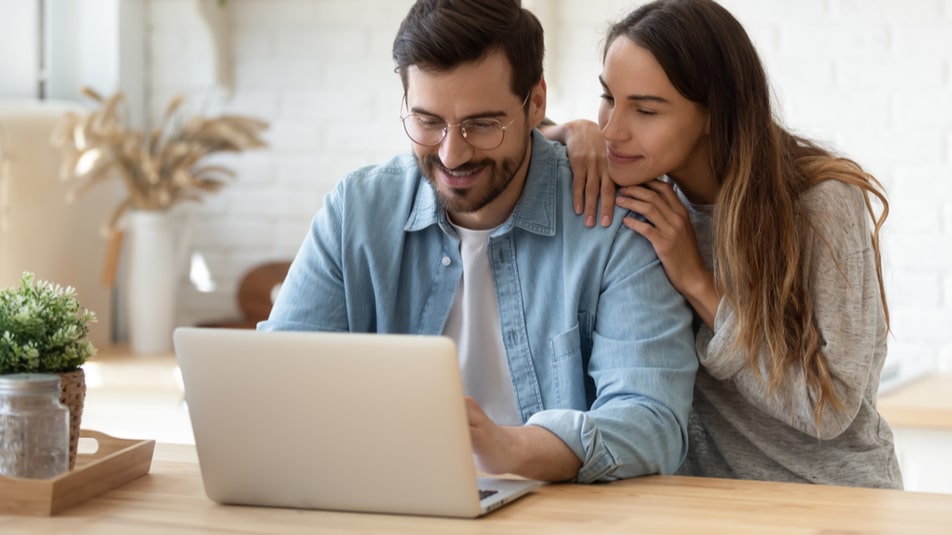 Couple viewing insurance policies on laptop