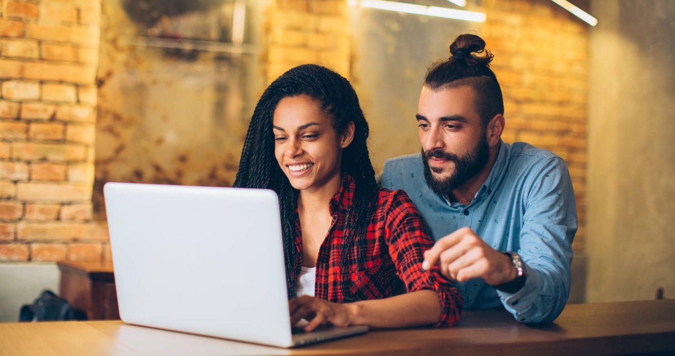 Couple viewing insurance policies on laptop